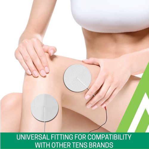 Two circular silver TENS unit electrode pads being applied to a person's upper thigh and knee, with the person's hands holding the skin. A green banner at the bottom reads 'UNIVERSAL FITTING FOR COMPATIBILITY WITH OTHER TENS BRANDS'.